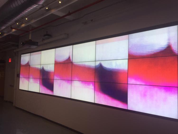 close up images of teeth and lips spread out on a large digital display screen grid.